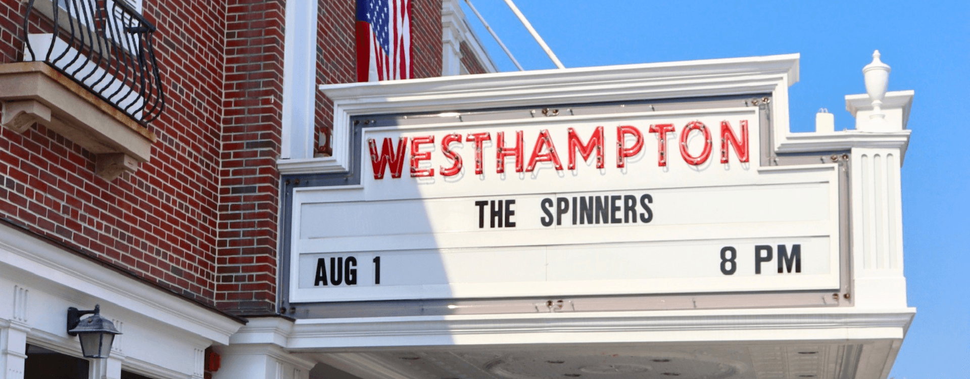 Marquee sign for the Westhampton venue advertising a performance by The Spinners on August 1 at 8 PM.